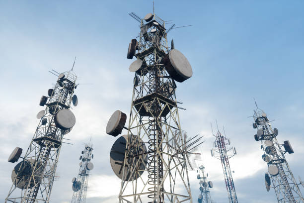 close up view of antenna towers with blue sky background